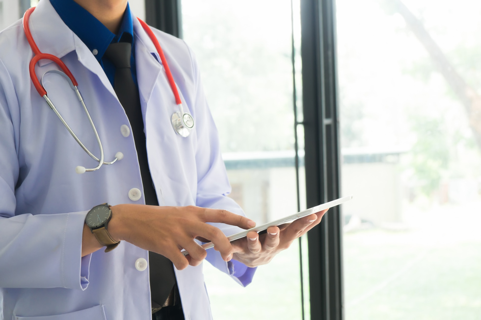 Doctor Holding Tablet